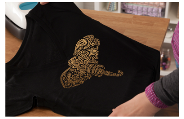 A black T-shirt on which an intricate design is applied with the help of Cricut EasyPress 2.